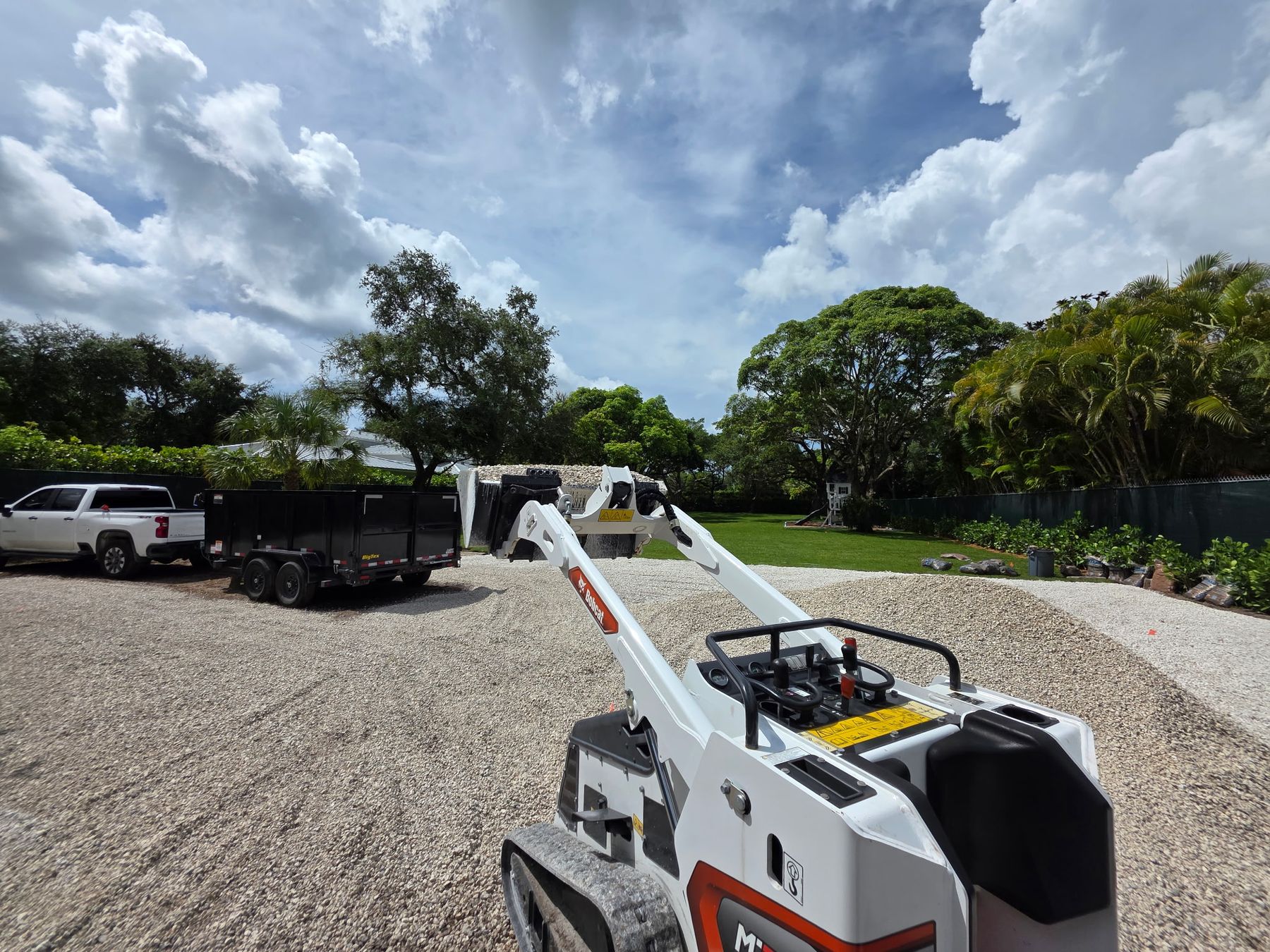 Walter's compact loader spreading white gravel for a new driveway